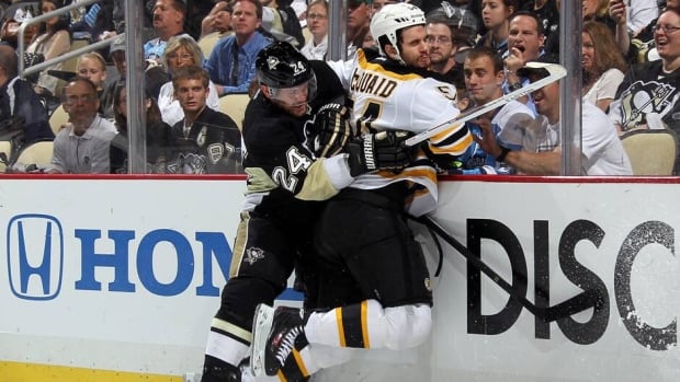 Penguins forward Matt Cooke, left, delivered a hit-from-behind to Boston Bruins defenceman Adam McQuaid, right, during Game 1 of the Eastern Conference final Saturday night at Consol Energy Center.