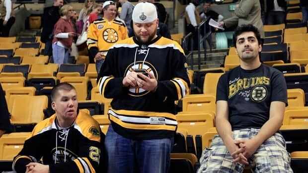 Dejected Boston Bruins fans linger at TD Garden after watching their team suffer a heart-breaking Game 7 loss to the Washington Capitals on Wednesday night.
