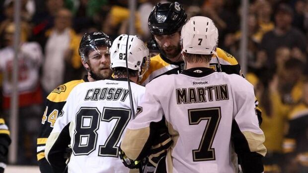 Dennis Seidenberg (44) and Zdeno Chara (33) of the Boston Bruins shake hands with Sidney Crosby (87) and Paul Martin (7) of the Pittsburgh Penguins after the Bruins eliminated the Penguins with a 1-0 Game 4 win in the Eastern Conference final Friday.