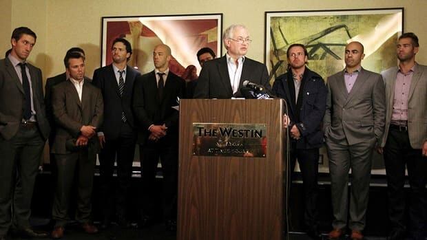 Donald Fehr, executive director for the NHLPA, is surrounded by hockey players as he speaks to reporters on Thursday, Dec. 6, 2012 in New York. Following the press conferences by Fehr and NHL Commissioner Gary Bettman, fans responded to the day's events on Twitter.