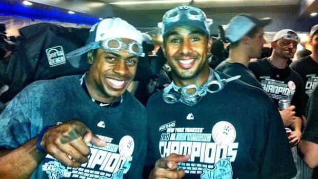 Chris Dickerson celebrates with New York Yankees teammates after Wednesday's clinching of the AL East title.