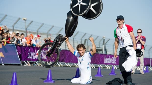 Former race car driver Alex Zanardi of Italy celebrates after winning the gold medal in the men's individual H4 time trial cycling final during the London 2012 Paralympic Games at Brands Hatch circuit, in Kent, southern England on September 5, 2012.