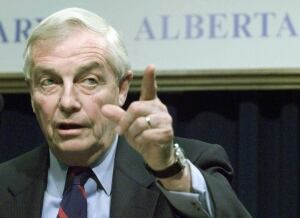 Former Alberta premier Peter Lougheed gestures during a news conference in Calgary on Oct. 1, 2002, after the first meeting of Alberta's anti-Kyoto committee. The committee is charged with advising the province on how it should proceed with its opposition to the Kyoto emissions control protocol and Canada's planned ratification. (Adrian Wyld/CP)