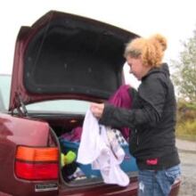 Nadine Hillier of Happy Valley-Goose Bay looks in the trunk of her car, where she's been sleeping.