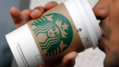 A customer sips a Starbucks coffee in this photo taken in Miami in 2011. Starbucks CEO Howard Schultz is this week urging Washington to end the government shutdown and the company is offering a petition to its customers. Earns Starbucks