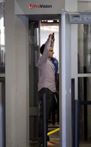 airport-security-scan-cp-9808627-220x356