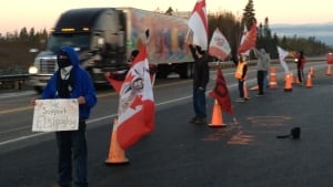Protesters stand by Highway 125 Friday morning.
