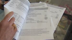 Tom Sada of Komoka Foodtown looks over his hydro bill
