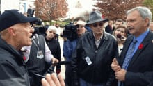 Finance Minister Blaine Higgs meets with pension protesters outside legislature.