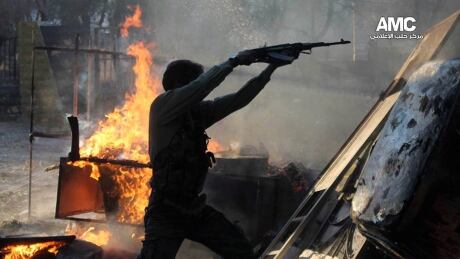 FILE - In this Friday, Nov. 8, 2013 file photo, citizen journalism image provided by Aleppo Media Center AMC which has been authenticated based on its contents and other AP reporting, a Free Syrian Army fighter fires an AK-47 during a battle against the Syrian army loyal to President Bashar Assad, in Aleppo, Syria. Despite global outrage over the use of chemical weapons, Assad�s government is successfully exploiting divisions among the opposition, dwindling foreign help for the rebel cause and significant local support, all linked to the same thing: discomfort with the Islamic extremists who have become a major part of the rebellion. (AP Photo/Aleppo Media Center AMC, File) Mideast Syria Tides of War