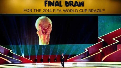 Spain coach Vicente del Bosque holds the World Cup trophy on stage before the Final Draw for the 2014 FIFA World Cup at Costa do Sauipe Resort last week in Costa do Sauipe, Bahia, Brazil. FIFA World Cup draw
