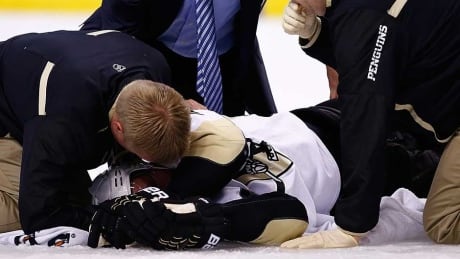 Brooks Orpik #44 of the Pittsburgh Penguins is tended to by the medical staff on the ice in the first period after an altercation with Shawn Thornton #22 of the Boston Bruins in the first period during the game at TD Garden on December 7, 2013 in Boston, Massachusetts. Brooks Orpik