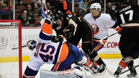 December 9, 2013; Anaheim, CA, USA; Anaheim Ducks right wing Corey Perry (10) collides with New York Islanders goalie Anders Nilsson (45) during the second period at Honda Center. Corey Perry, Islanders