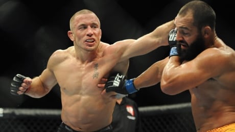 Georges St-Pierre, left, lands a punch on Johny Hendricks in their welterweight title fight in UFC 167 at Las Vegas on Nov. 16. The Montreal fighter is stepping away from the octagon for a mental break but vowed on Friday he would return.
stpierre-georges-131116