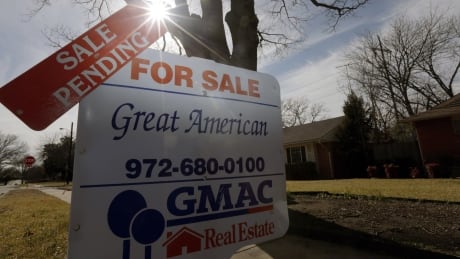 In this Friday, Feb. 22, 2013 file photo, a sale pending announcement sits atop a for sale sign in a home's yard in Richardson, Texas. National Association of Realtors releases pending home sales index for November on Monday, Dec. 30, 2013. U.S. Pending Home Sale