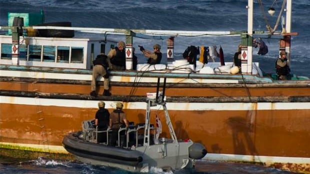 Members on the Halifax-class frigate HMCS Toronto board a suspected drug-smuggling vessel.