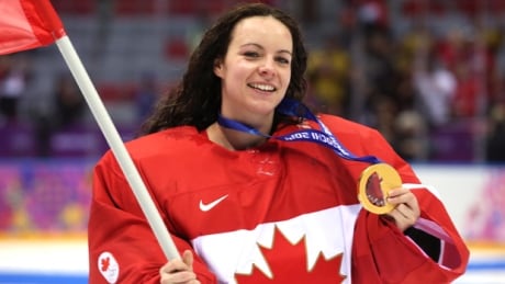 SOCHI, RUSSIA - FEBRUARY 20: Shannon Szabados #1 of Canada celebrates during the flower ceremony after defeating the United States 3-2 in overtime during the Ice Hockey Women's Gold Medal Game on day 13 of the Sochi 2014 Winter Olympics at Bolshoy Ice Dome on February 20, 2014 in Sochi, Russia. szabados-shannon-140220