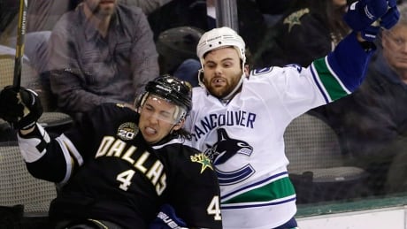 Canucks forward Zack Kassian, right, will have a phone hearing with the NHL for his hit from behind against Dallas' Brenden Dillon, left, during Thursday's 6-1 win by the Stars. The two have met on the ice previously as seen by this Kassian hit during a Feb. 21, 2013 contest in Dallas. kassian-zack-04028818