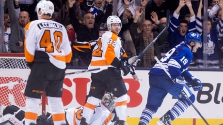 Toronto Maple Leafs' Joffrey Lupul, right, celebrates after scoring the game-winning overtime goal as Philadelphia Flyers defenceman Mark Streit, centre right, looks over at Flyers' Vincent Lecavalier on Saturday. Leafs, Flyers