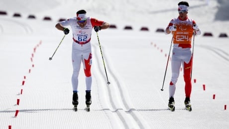 Brian McKeever, left, with guide Erik Carelton, won Canada's first Paralympic gold in Sochi. McKeever-140310