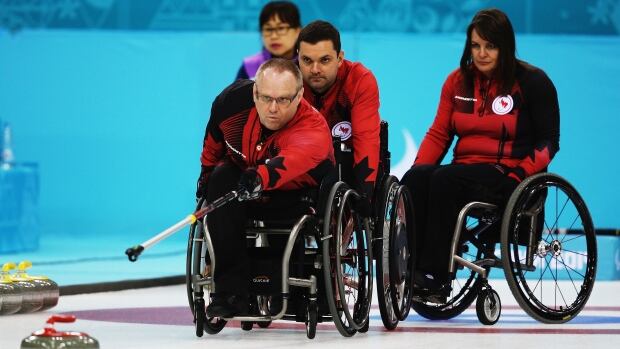 Dennis Thiessen of Canada throws a rock during a match against South Korea.