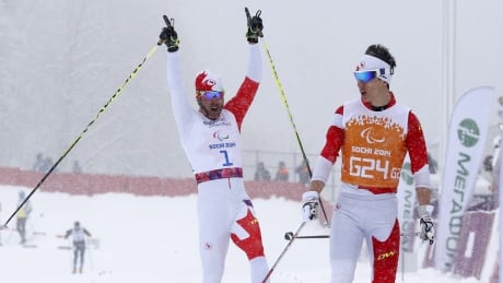 Canada's Brian McKeever, left, and his guide Graham Nishikawa made a spectacular recovery to win gold in the men's cross-country one-kilometre visually impaired race on Wednesday at the Sochi Paralympics. Brian McKeever wins 1K sprint at Sochi Paralympics