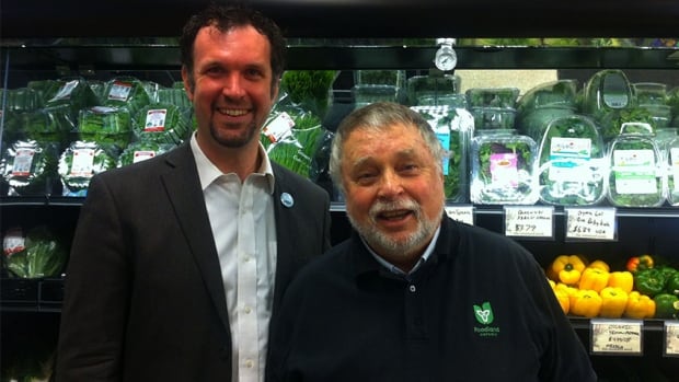 Graham Cubitt and Ted McMeekin pose together at Mustard Seed Co-op in downtown Hamilton. McMeekin announced the province will provide funding for the co-op Friday morning.