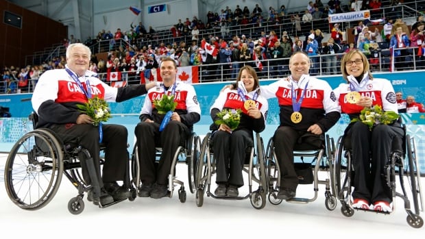 Wheelchair curling gold medallists, from left, Jim Armstrong, Joe Rea, Ina Forrest, Dennis Thiessen and Sonja Gaudet pose after winning gold — Canada's third straight at the Paralympics — on Saturday after defeating Russia.