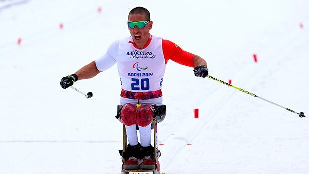 Canada's Chris Klebl powers across the finish line in the men's 10 km sitting cross-country race at the Paralympics.