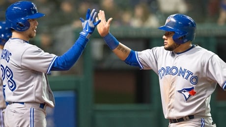 Colby Rasmus, left, celebrates with Melky Cabrera of the Toronto Blue Jays after Cabrera scored on a single by Edwin Encarnacion (not pictured) during the seventh inning against the Cleveland Indians in Cleveland, Ohio on Friday. melky cabrera blue jays indians