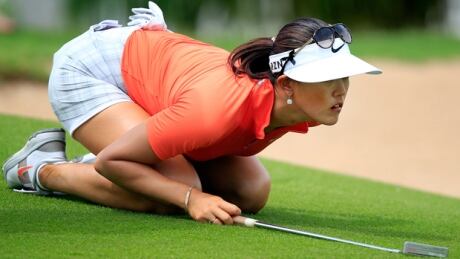 Michelle Wie lines up a putt in Saturday's final round of the LPGA Lotte Championship at Ko Olina Golf Club in Kapolei, Hawaii. wie-michelle-140419