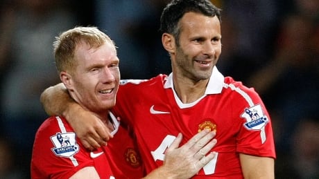 Interim Manchester United coach Ryan Giggs, right, seen here with teammate Paul Scholes during a Aug. 16, 2010 match. Scholes will assist Giggs along with fellow ex-teammates Nicky Butt and Phil Neville following the dismissal of David Moyes. giggs-ryan-06227570