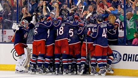 Somewhere in that pile, Nick Foligno is congratulated by his Blue Jackets teammates after beating Marc-Andre Fleury (not pictured) of the Pittsburgh Penguins for the game-winning goal during the overtime period in Game 4 on Wednesday in Columbus, Ohio. blue jackets comeback social media penguins game 4