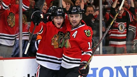 GAME 4: Patrick Kane (88) and Patrick Sharp (10) of the Chicago Blackhawks celebrate a second period goal by Kane against the St. Louis Blues in Chicago. blues-hawks game 4-1