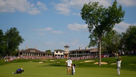 Bubba Watson, right, hits an approach shot on the 18th hole in the third round of the Memorial at Muirfield Village on Saturday. watson-bubba-140531