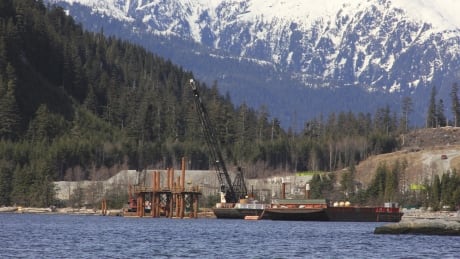 Cranes work in the water at the Kitimat LNG site near Kitimat, in northwestern British Columbia on April 13, 2014. British Columbia is on the brink of an energy boom. Domestic and foreign companies are looking to build two oil pipelines, multiple natural gas lines and a dozen liquefied natural gas plants to gain access to the massive Asian market and reduce their reliance on U.S. Buyers. Kitimat LNG