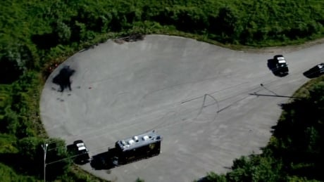 Aerial footage shows police vehicles and the charred site where three human bodies were found in the remains of a burned-out car near Barrie, Ont. on July 4 2014. barrie-bodies-20140704