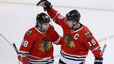 Chicago Blackhawks center Jonathan Toews (19) celebrates his goal with Patrick Kane during the third period of an NHL hockey game against the Columbus Blue Jackets on Thursday, March 6, 2014, in Chicago. The Blackhawks won 6-1. (AP Photo/ kane-toews-620