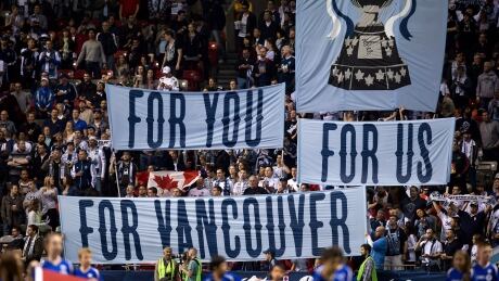 Fans hold up banners before the Vancouver Whitecaps and Montreal Impact play in the Canadian Championship soccer game in Vancouver, B.C., on Wednesday May 29, 2013. Canadian Championship Soccer 20130529
