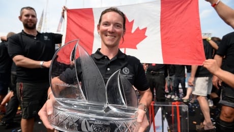 Henri Lloyd skipper Eric Holden celebrates with the Clipper Race trophy on the podium after the Round the World Race Finish in London. Eric Holden - Clipper Race trophy, July 12, 2014