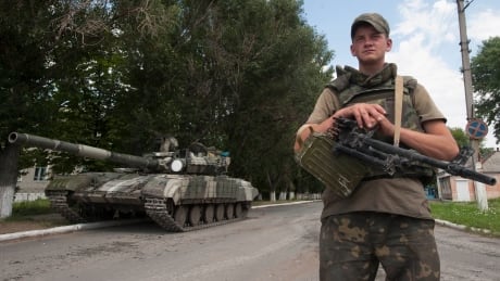 A Ukrainian government soldier guards a checkpoint just outside the city of Siversk, Donetsk region, eastern Ukraine, Saturday, July 12, 2014. Pro-Russian insurgents last week retreated from the strategic city of Slovyansk and holed up in Donetsk, a city of one million, and potentially the final frontier for the rebels. (AP Photo/Evgeniy Maloletka) Ukraine crisis