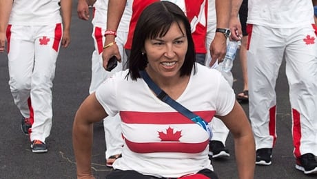 Chef de mission Chantal Petitclerc leads the way as the Canadian team arrives at its welcome ceremony at the Commonwealth Games in Glasgow, Scotland on Monday. chantal-petitclerc
