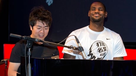 NBA basketball star LeBron James, right, plays piano with renowned pianist Lang Lang of China, left, during a Nike-sponsored event in Beijing. james-lang-620