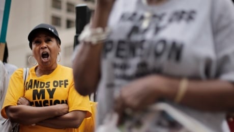 FILE- Retiree Evelyn Smith, left, protests near the federal courthouse in Detroit on July 3, 2014. Ballots submitted by city workers, retirees, pensioners and other creditors likely will determine how quickly Detroit exits its historic bankruptcy. On Monday, July 14, 2014, city lawyer Heather Lennox told federal Judge Steven Rhodes that the results of voting by retirees on a proposed bankruptcy settlement should be reported the week of July 21, 2014. General retirees would see a 4.5 percent cut and also lose annual inflation adjustments. Police officers and firefighters would lose a portion of their annual cost-of-living payment. (AP Photo/Paul Sancya, File) Detroit Bankruptcy