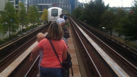 After the trains stopped many riders pried open the doors and began walking along the tracks to the nearest station. TransLink SkyTrain shutdown