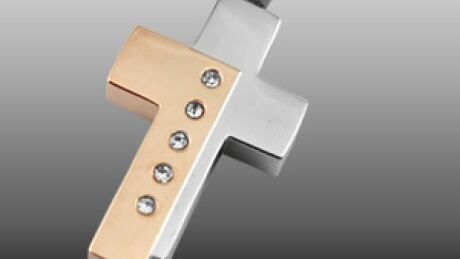 This cross pendant, about four centimetres high and two centimetres wide, has five crystals and hangs on a silver chain. It holds the remains of Dawson Pentecost, who was killed in a plane crash last year in Manitoba. Cross pendant
