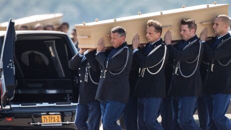 Coffins of the victims of Malaysia Airlines MH17 downed over rebel-held territory in eastern Ukraine, are loaded into hearses on the tarmac during a national reception ceremony at Eindhoven airport July 23, 2014. Two aircraft carrying the remains of some of the 298 passengers who died on flight MH17 touched down at an airport in the Dutch city of Eindhoven on Wednesday, as next-of-kin and Dutch and foreign officials looked on. The remains of the victims of the downing of the flight over eastern Ukraine, 193 of whom were Dutch, will be brought over the next few days to a military base in Hilversum, the Netherlands. The Netherlands declared Wednesday the country's first day of mourning in more than half a century. REUTERS/Mischa Rapmund (NETHERLANDS - Tags: TRANSPORT POLITICS DISASTER CIVIL UNREST) - RTR3ZUBD Netherlands repatriation ceremony coffin