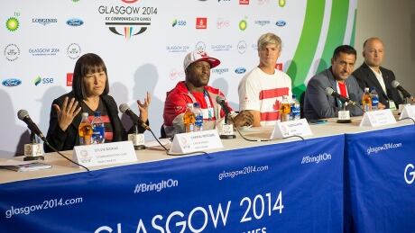 Canada's chef de mission Chantal Petitclerc, left, and boxer Custio Clayton, second from left, meet with the media upon arriving at the Commonwealth Games in Glasgow, Scotland. Many Canadian athletes took to Twitter Wednesday to share their first impressions. canadapressconference-clayton