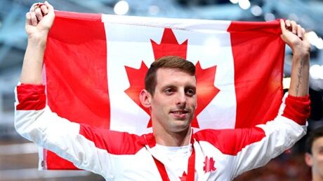 GLASGOW, SCOTLAND - JULY 24: Ryan Cochrane of Canada poses with his national flag after winning the Men's 400m Freestyle Final at Tollcross International Swimming Centre during day one of the Glasgow 2014 Commonwealth Games on July 24, 2014 in Glasgow, Scotland. cochrane-canada-140724-620