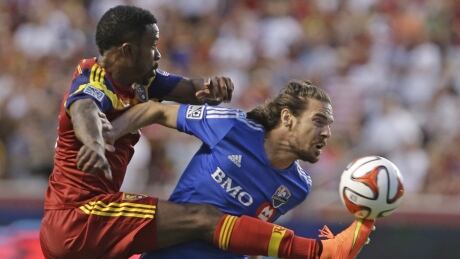 Real Salt Lake's Robbie Findley, left, kicks the ball as Montreal Impact's Heath Pearce (44) defends during the first half on Thursday. MLS Impact Real Salt Lake Soccer